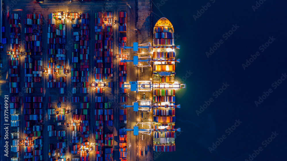 Aerial view container ship at night, import export commerce global business trade logistic and trans