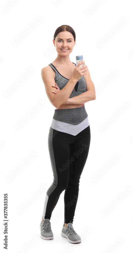 Sporty young woman with bottle of water on white background