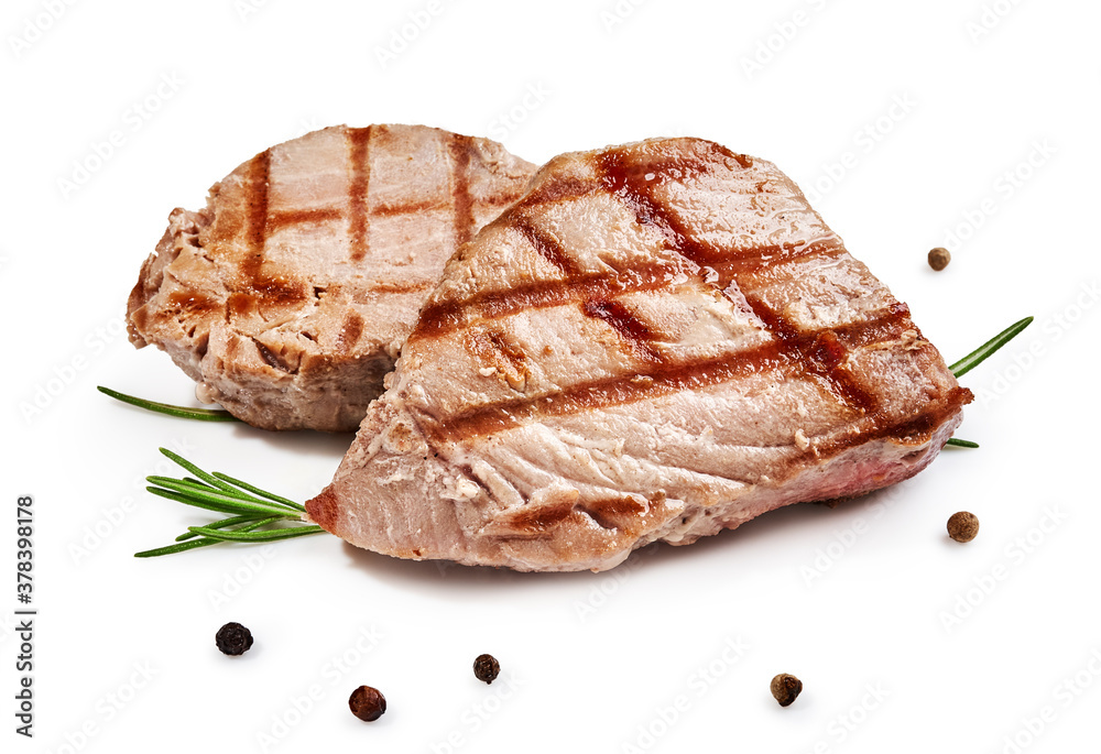 Two grilled tuna steak with rosemary and spices isolated on white