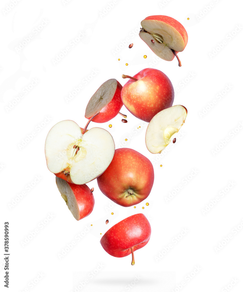 Whole and sliced ​​fresh red apples in the air isolated on a white background