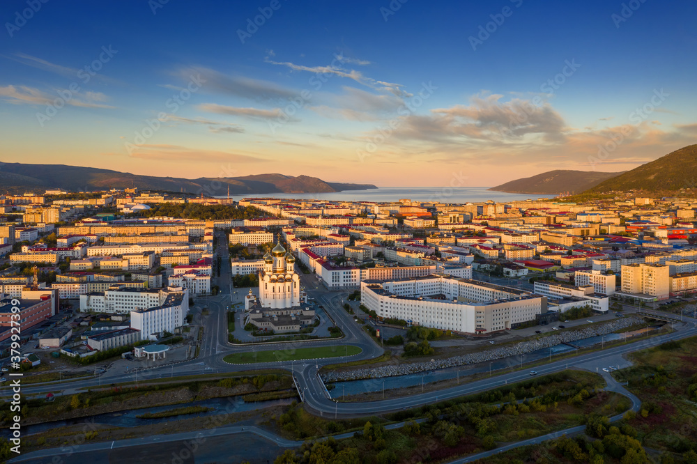 Picturesque morning aerial view of the city of Magadan. Top view of the Cathedral, streets and build
