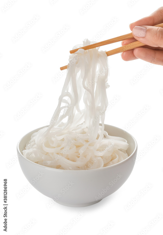 Woman eating tasty rice noodles on white background
