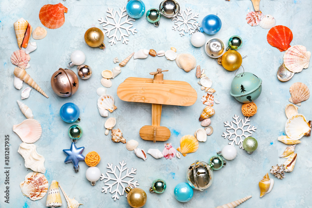 Composition with Christmas decor and airplane on color background