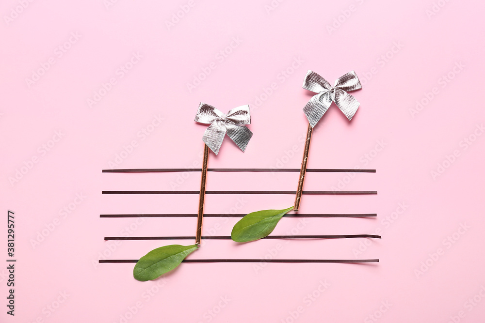 Music notes made of different materials on color background