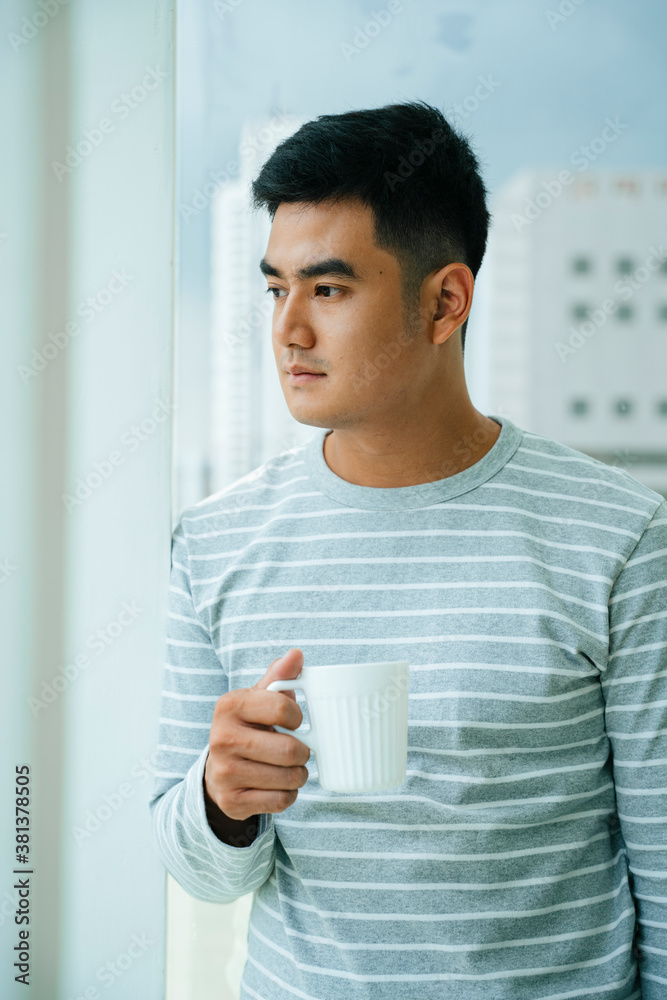 Asian man enjoy hot coffee in the morning.