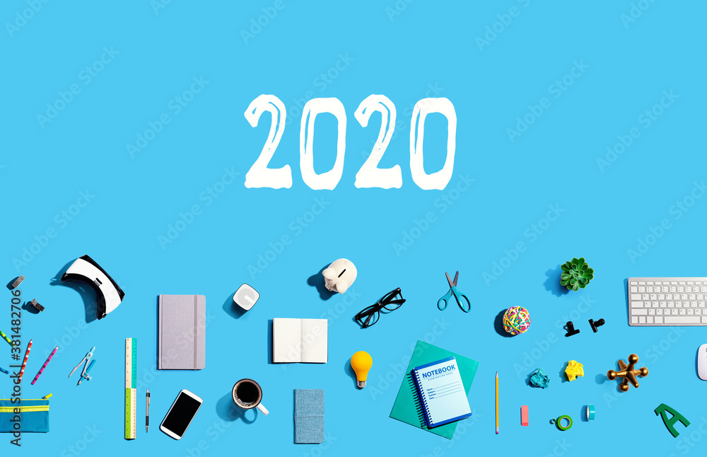 2020 new year concept with collection of electronic gadgets and office supplies