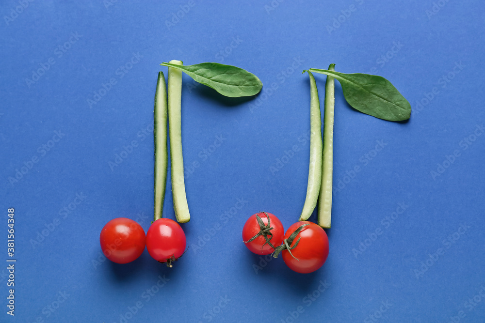 Music notes made of fresh vegetables on color background