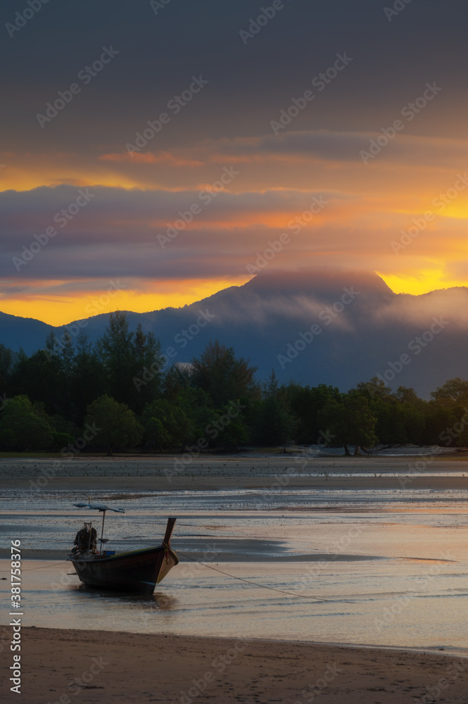 Beautiful scene of Bang ben beach and long tail boat with vivid sky in morning in Ranong province, T