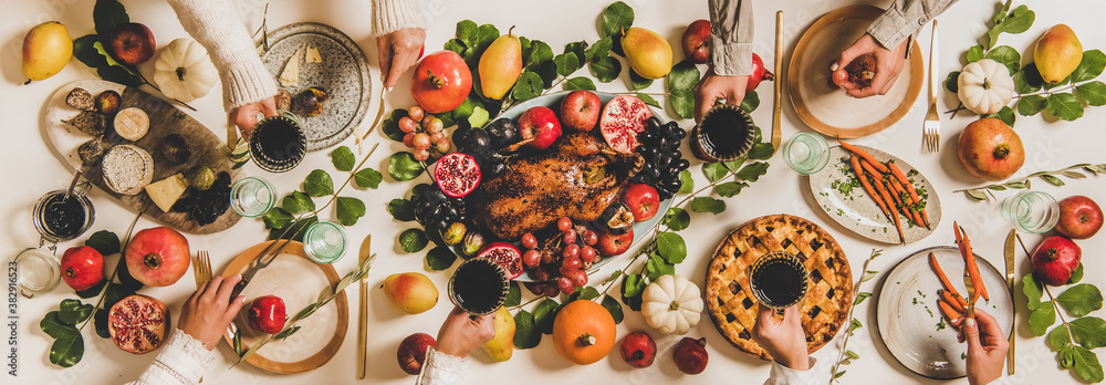Autumn Thanksgiving, Friendsgiving, family party dinner. Flat-lay of peoples hands with wineglasses 