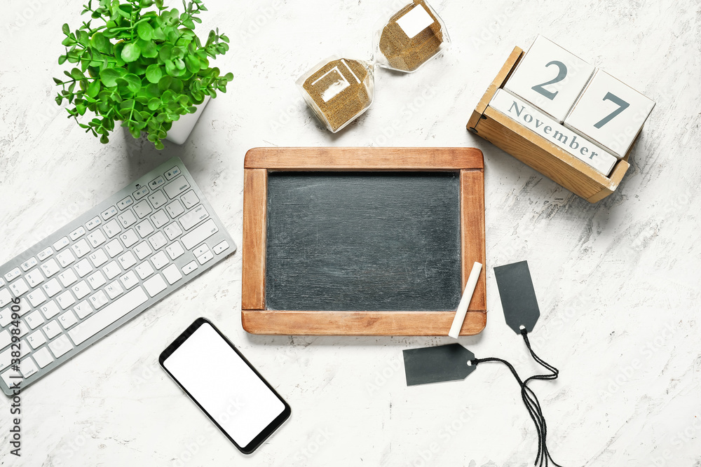 Empty chalkboard, computer and calendar with date of Black Friday sale on white background