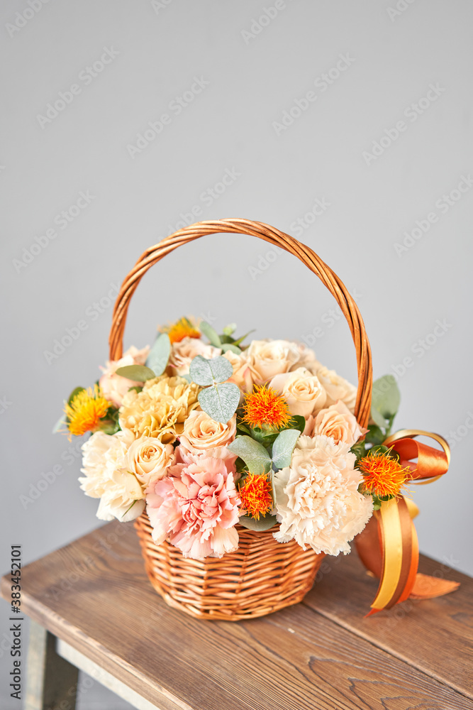 Small flower shop and Flowers delivery. Flower arrangement in Wicker basket. Beautiful bouquet of mi
