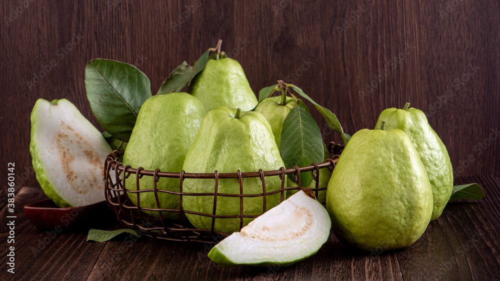 Close up of delicious guava with fresh green leaves.
