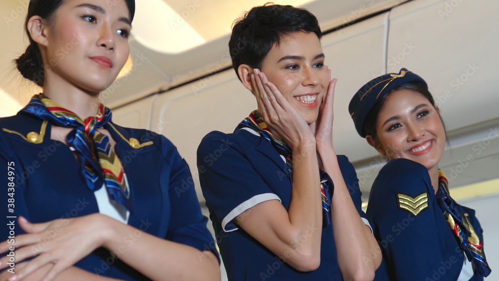 Cabin crew dancing with joy in airplane . Airline transportation and tourism concept.