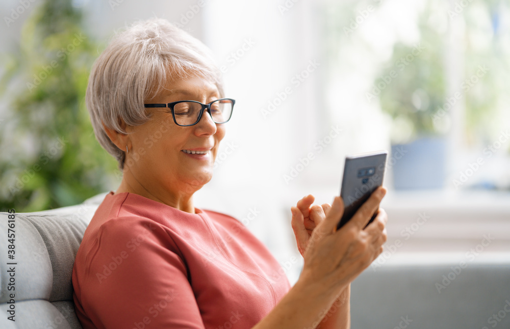 senior woman is using smartphone