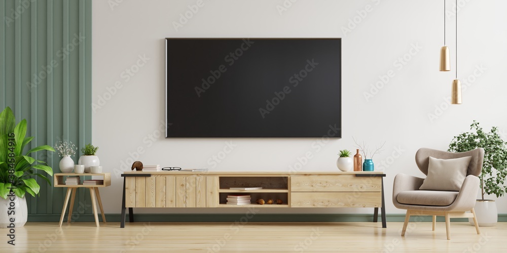 TV on the white wall in living room with armchair,minimal design.