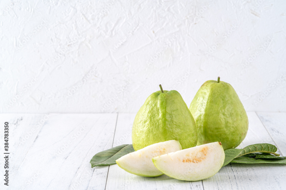 Delicious guava fruit set on white wooden table background with copy space.