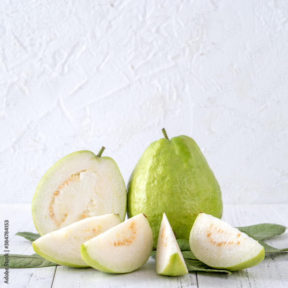 Delicious guava fruit set on white wooden table background with copy space.