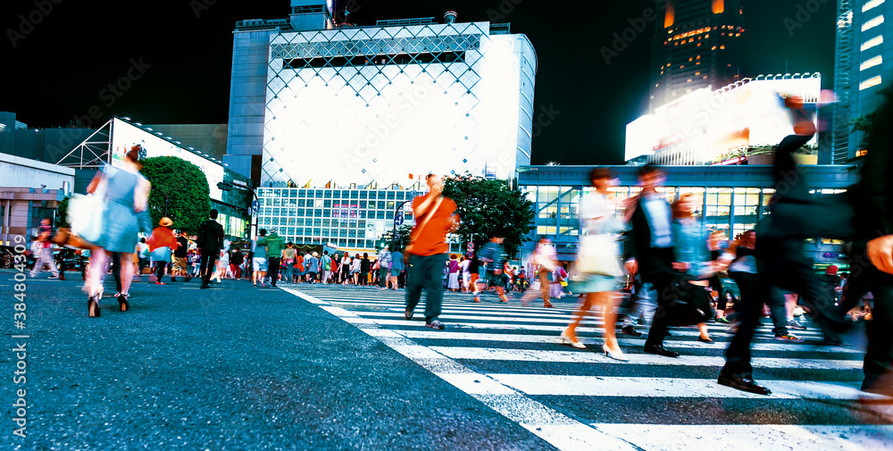 People and traffic cross the famous scramble intersection in Shibuya, Tokyo, Japan, one of the busie