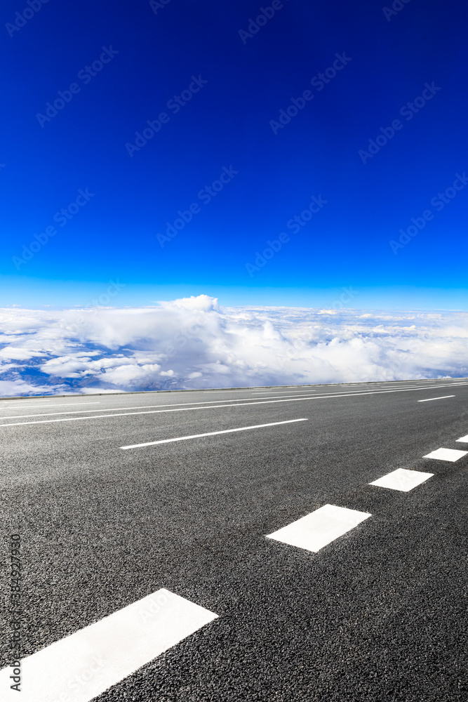 Empty asphalt road and blue sky with white clouds scenery.