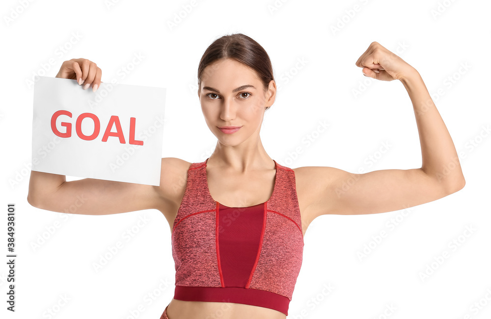 Sporty woman holding paper with text GOAL on white background