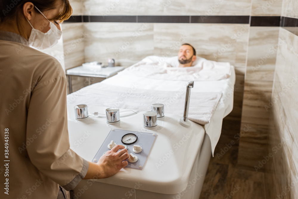 Man relaxing during a medical treatment at the bath filled with carbon dioxide at balneology room wi