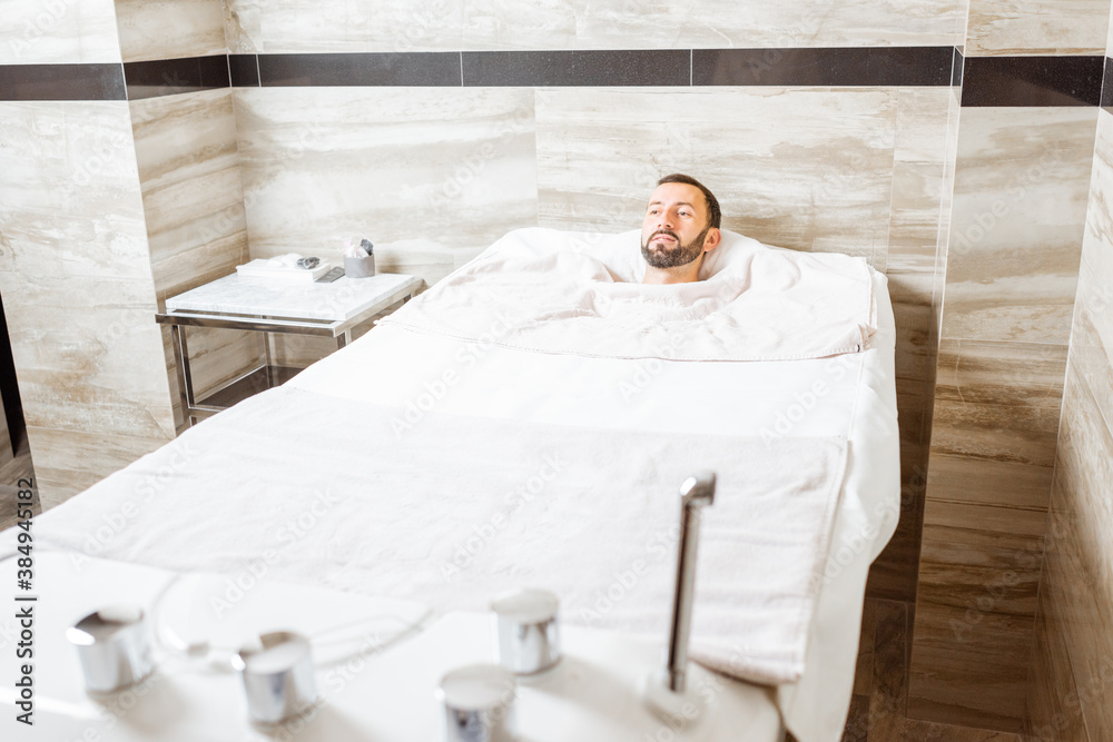Man relaxing during a medical treatment at the bath filled with carbon dioxide at balneology room