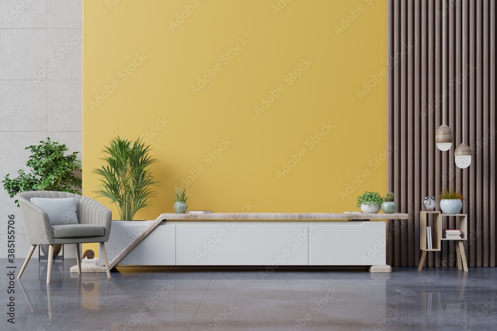 Cabinet TV in modern living room with armchair,lamp,table,flower and plant on yellow wall background