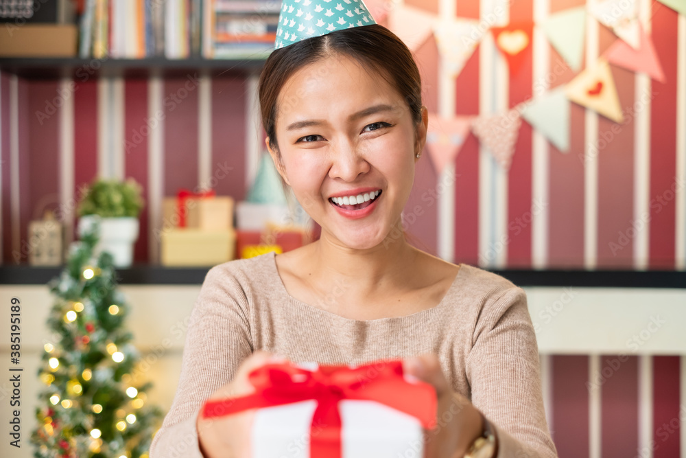 POV Asian woman giving gift or present to friends and family via video call conference. new normal f