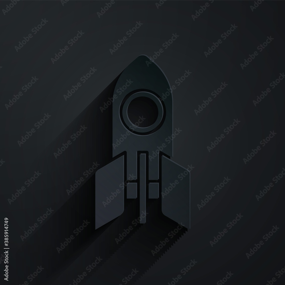 黑色背景上的剪纸火箭飞船图标。太空旅行。纸艺术风格。矢量。