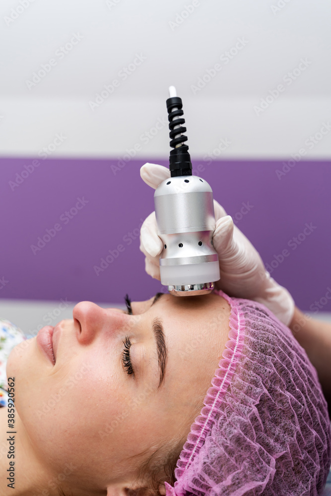 Face skin care. Woman getting facial hydro microdermabrasion peeling. Beauty clinic.