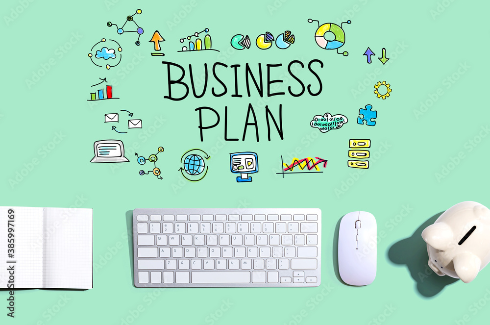 Business plan with a computer keyboard and a piggy bank