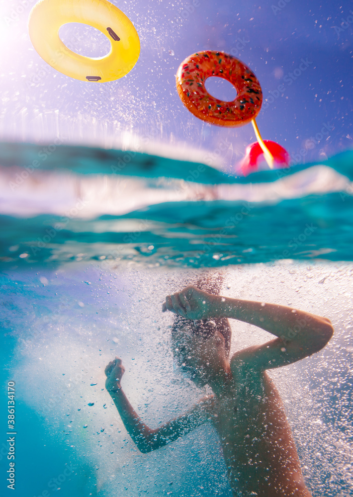 Split photo of a kid dive in the water of swimming pool with bubbles splashes and flying inflatable 