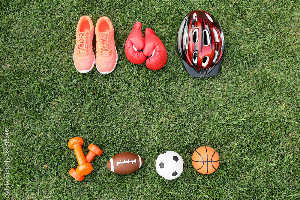 Set of sport equipment on green grass