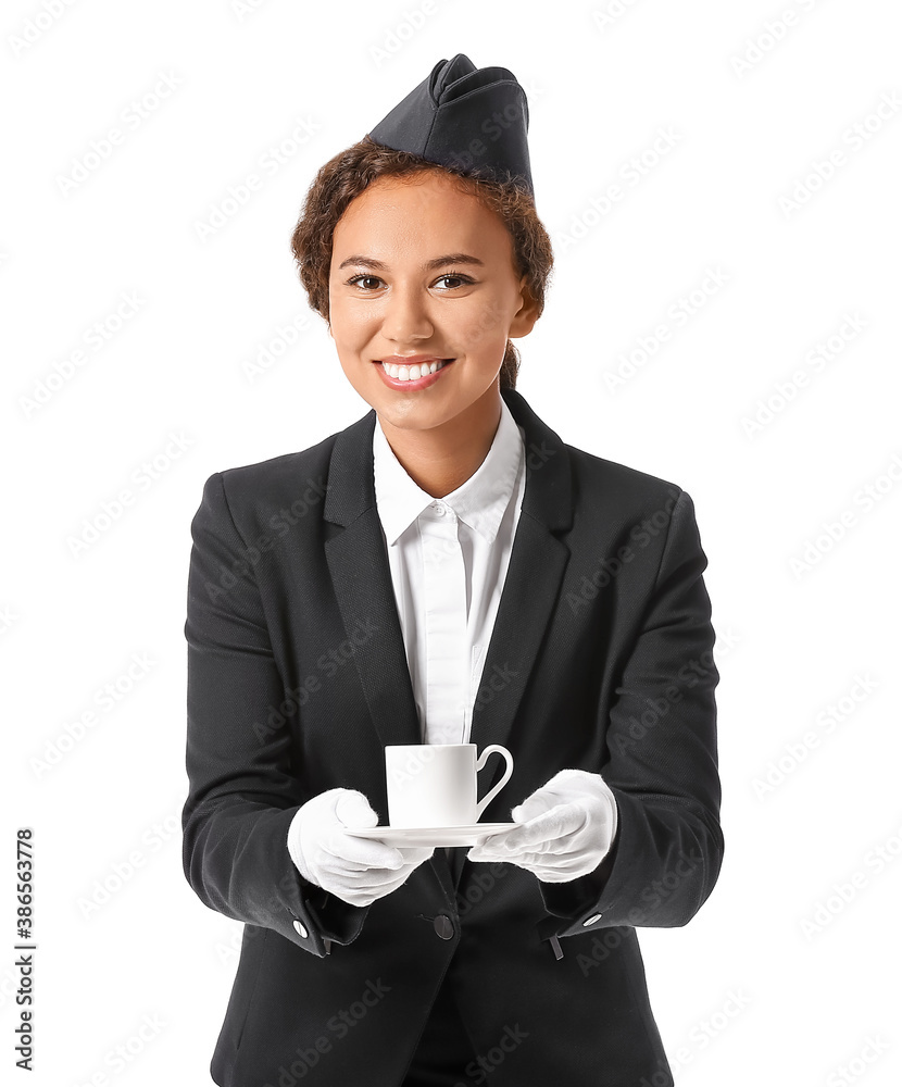 Beautiful African-American stewardess with cup of coffee on white background