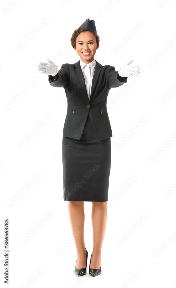 Beautiful African-American stewardess on white background