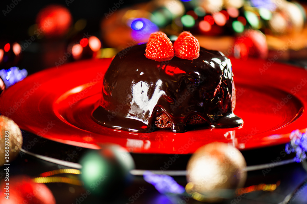 Festive photo of a Christmas Pudding on a vibrant red plate. Dessert background.