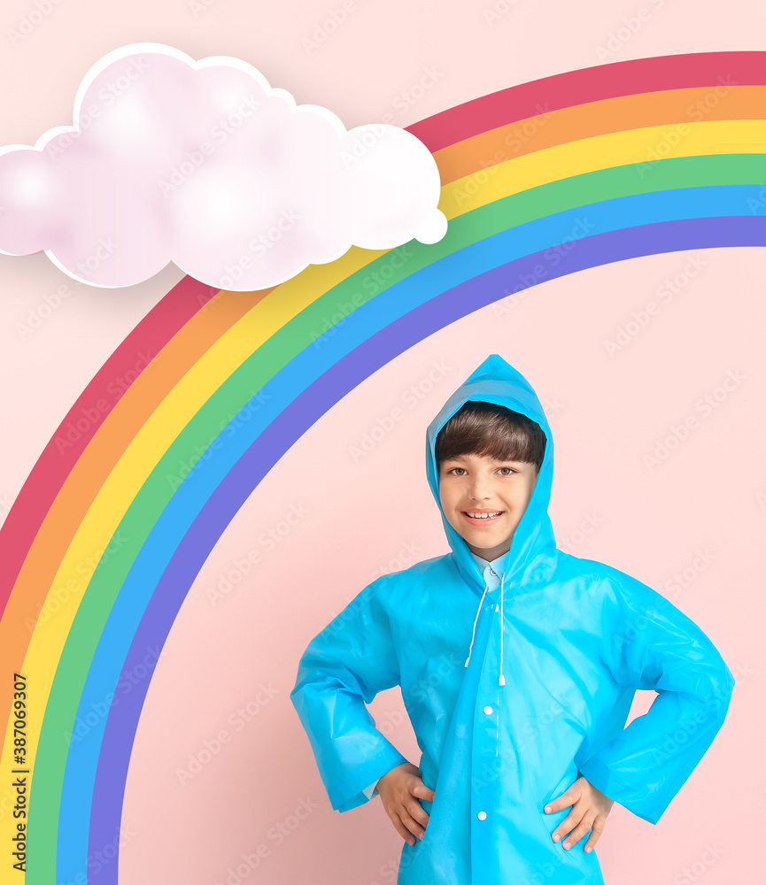 Cute little boy in raincoat on color background with drawn rainbow