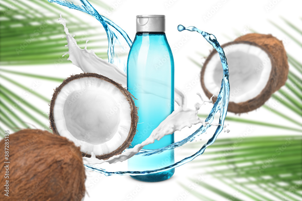 白色背景上有一瓶洗发水、飞溅物和椰子的成分