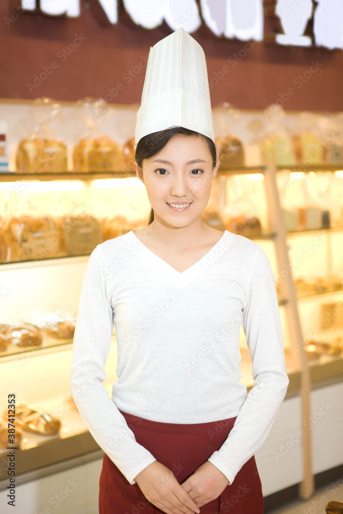 The happy bakery saleswoman is in the bakery