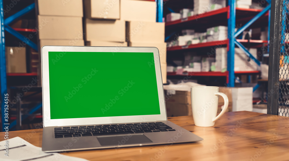 Computer with green screen display in warehouse storage room . Delivery and transportation software 