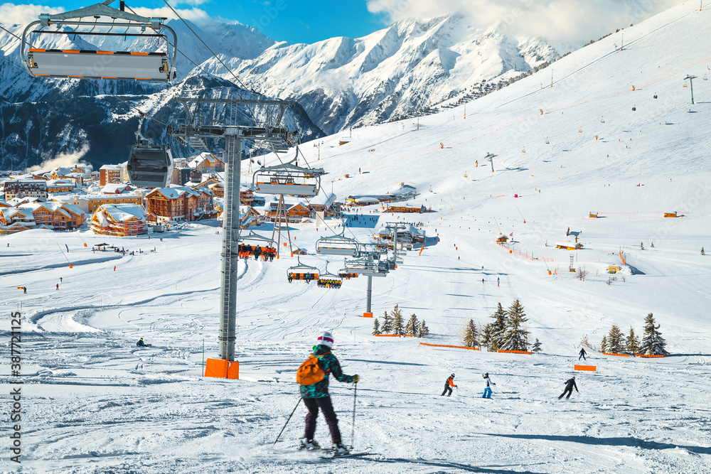 Skiers exercising on the slope and ski lifts, France, Europe
