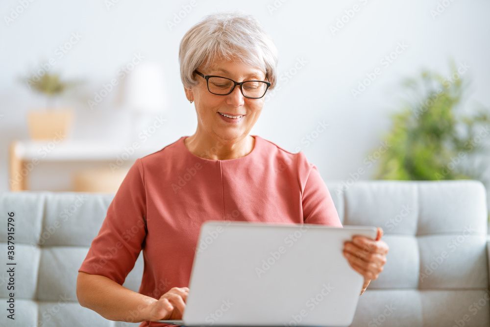 senior woman is using laptop