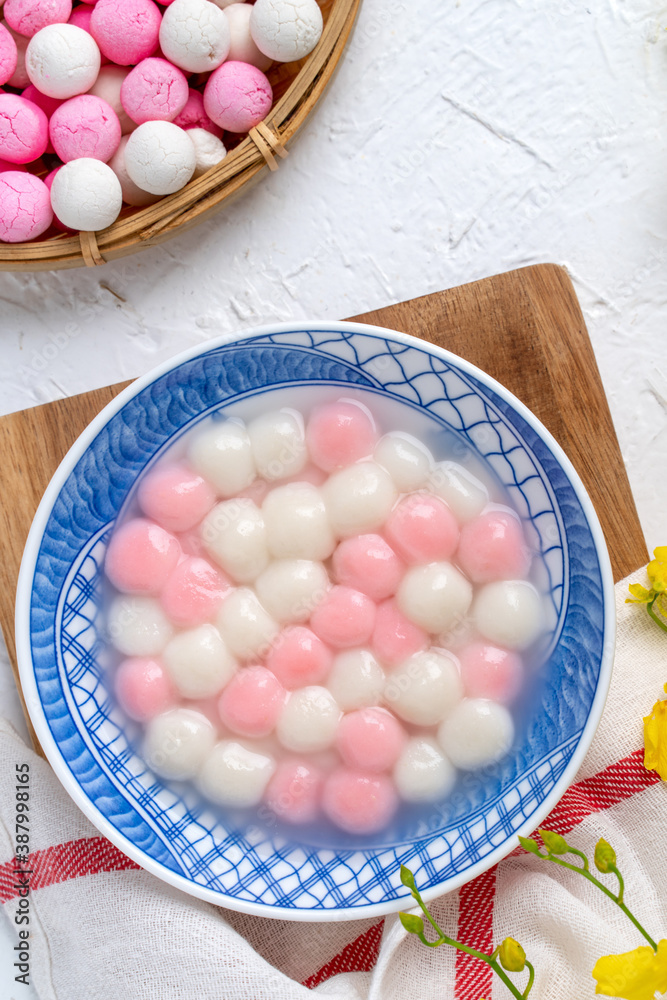 Top view of red and white tangyuan in blue bowl on white background for Winter solstice.