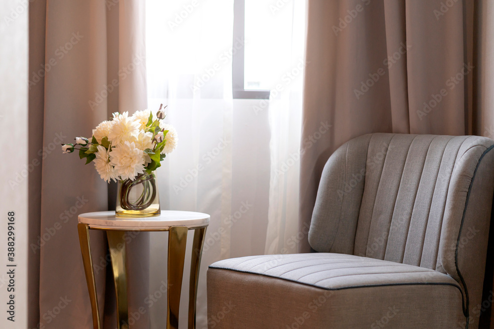 带侧桌和白色花瓶的家用室内家具织物扶手椅，带窗户照明