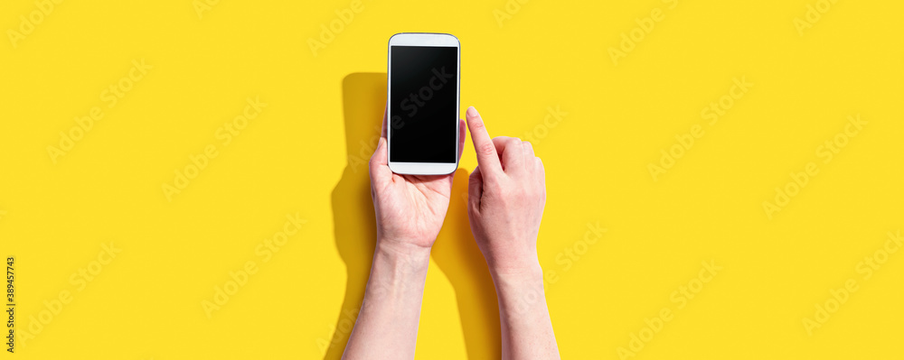 Person using a white smartphone from above