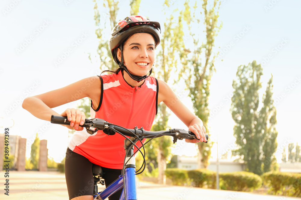 Female cyclist riding bicycle outdoors