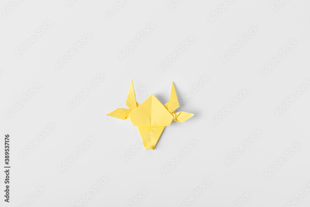 Origami bull as symbol of year 2021 on white background