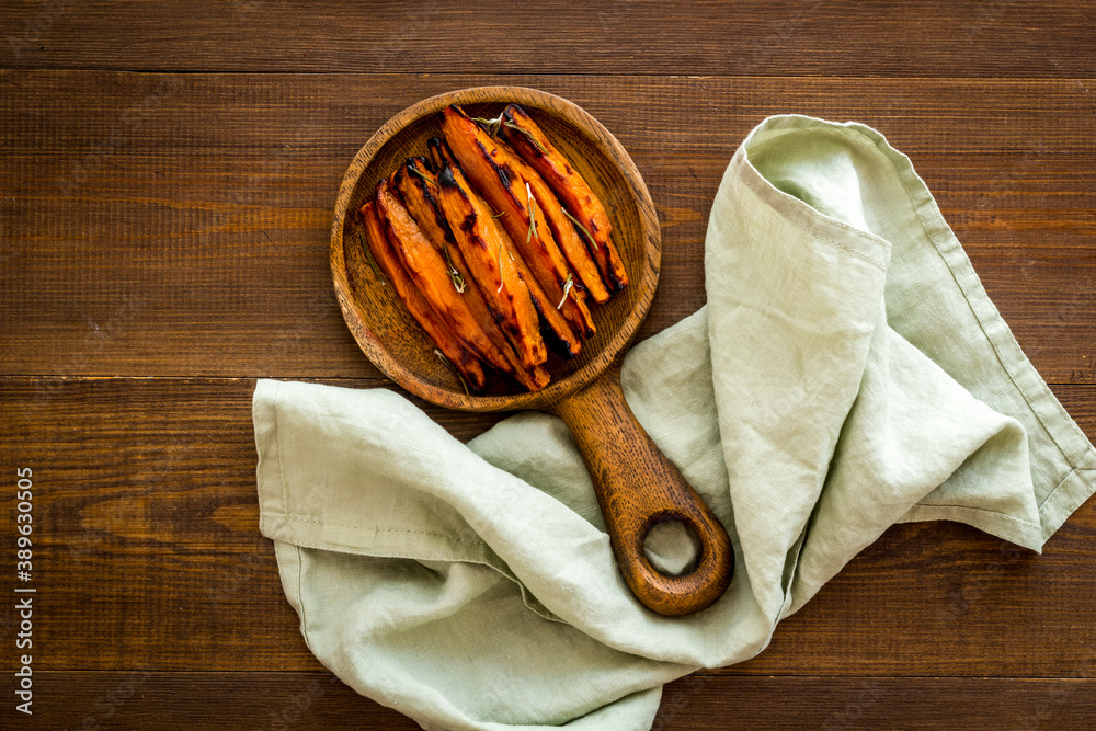 Roasted sweet potato - vegetable snack with herbs, view from above