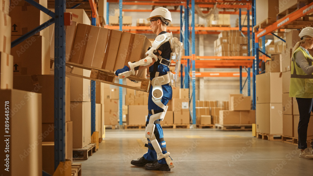 高科技未来仓库：工人穿着先进的全身动力外骨骼，举起沉重的P