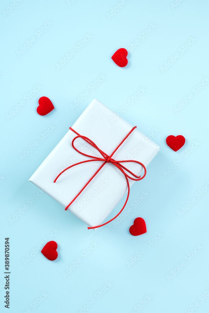 Valentines Day greeting design concept - Top view of gift box on bright blue background.